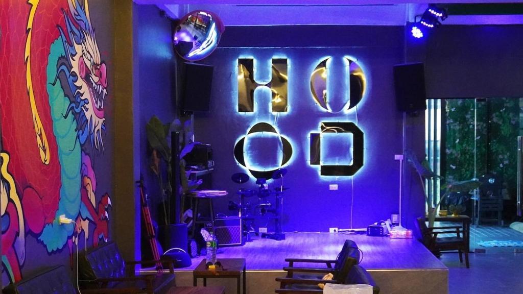 a room with a purple wall with the word disco at Hood Pattaya in Pattaya