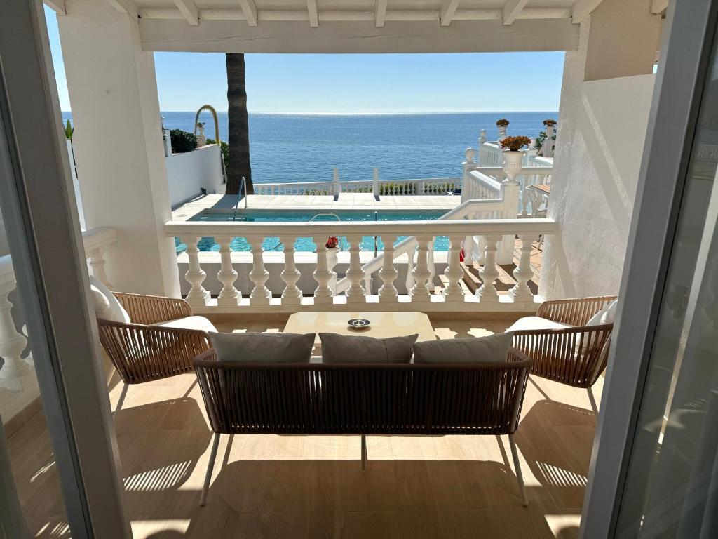 a view of the ocean from the balcony of a house at Hotel Paraíso Del Mar in Nerja