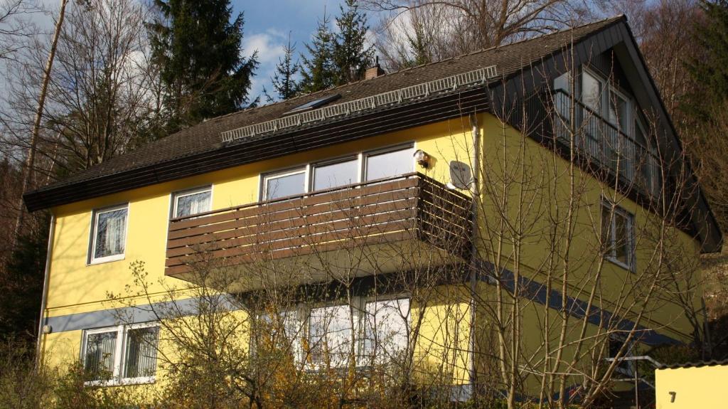 a yellow house with a brown roof at Ferienwohnung Schwäbische Alb in Burladingen