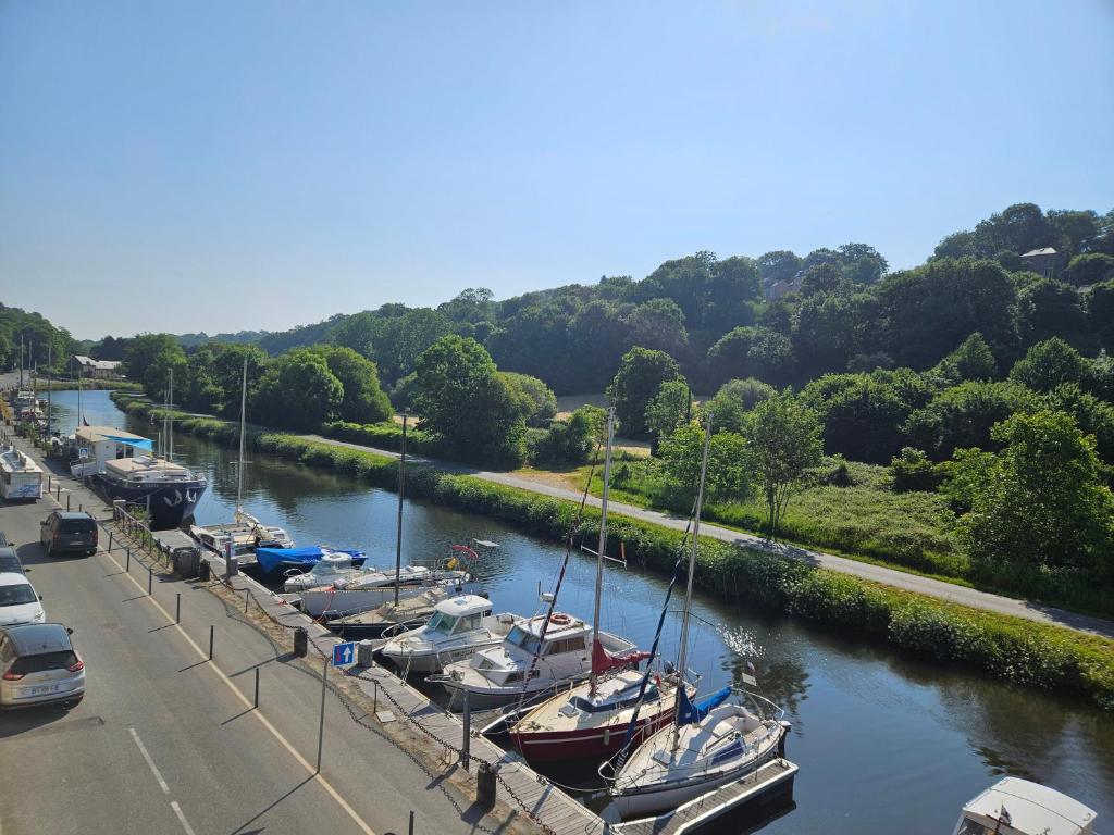 a bunch of boats are docked in a river at Escapade sur le port de Dinan in Dinan