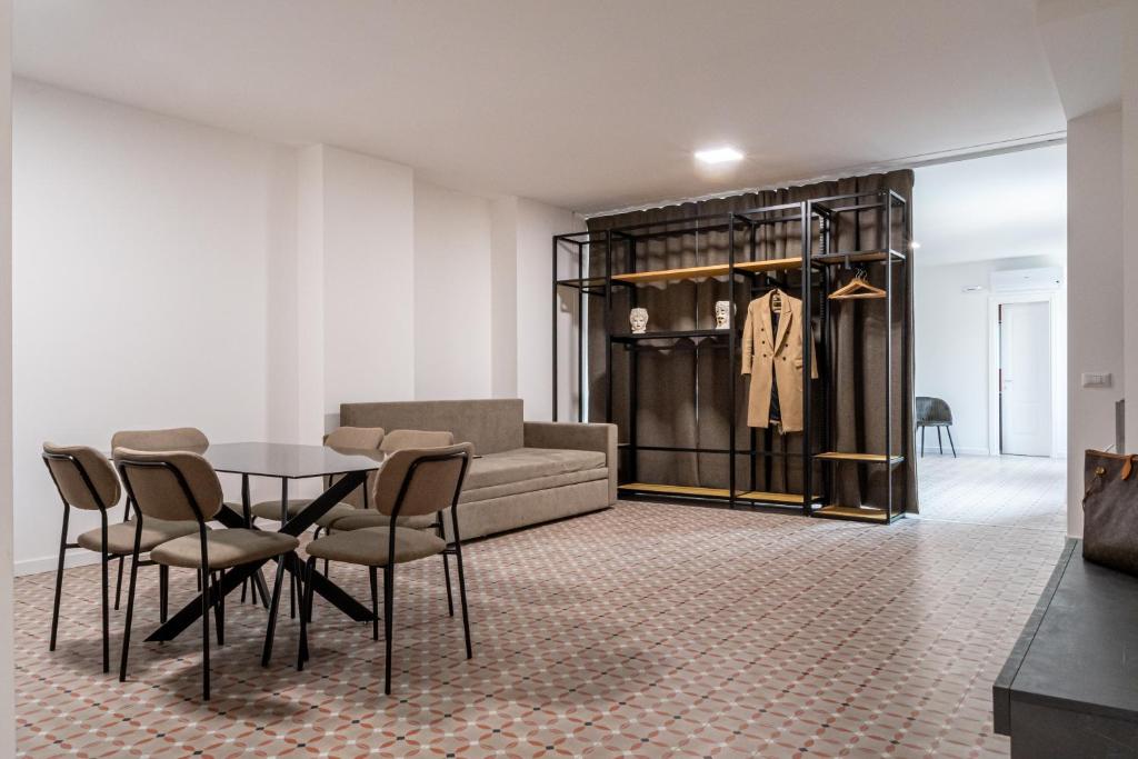 a living room with a table and a couch at 20Miglia Albergo Diffuso - Via Giovanni Di Prima in Catania