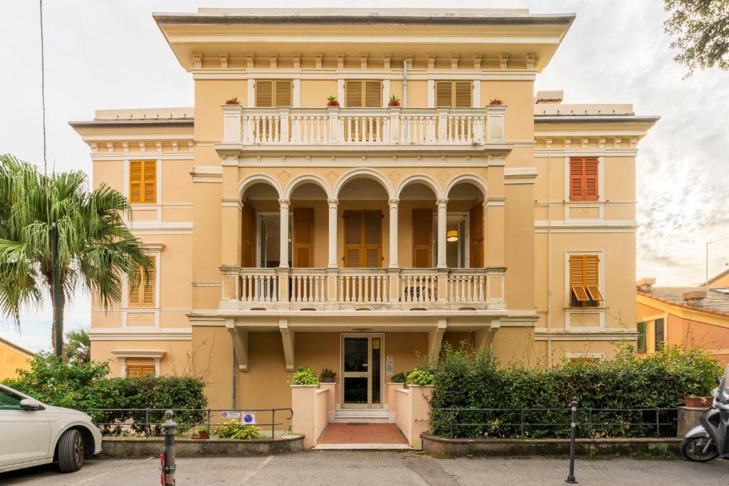 a large yellow house with a balcony at Beatrice House, Bogliasco, Sea Access, Ac in Bogliasco