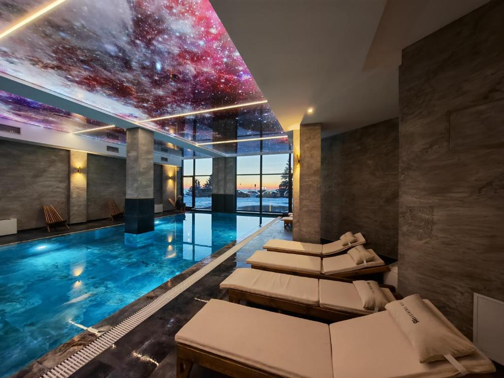 a hotel swimming pool with a star ceiling at Apartman Aska - Residence Hill in Kopaonik