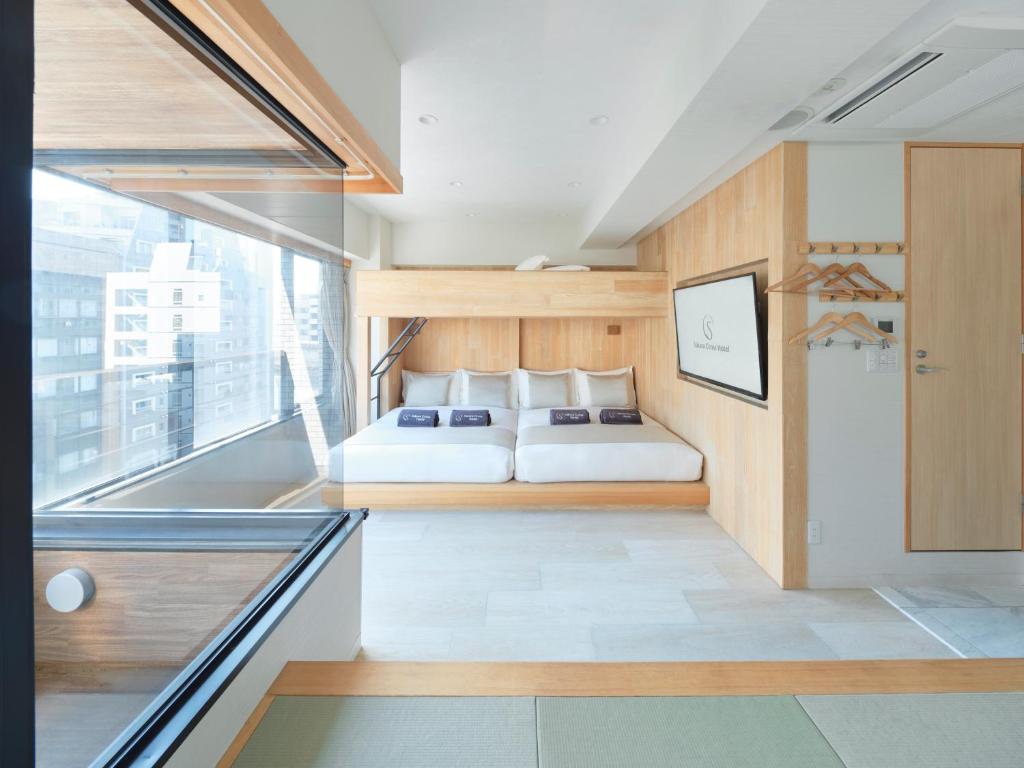 Postel nebo postele na pokoji v ubytování Sakura Cross Hotel Akihabara