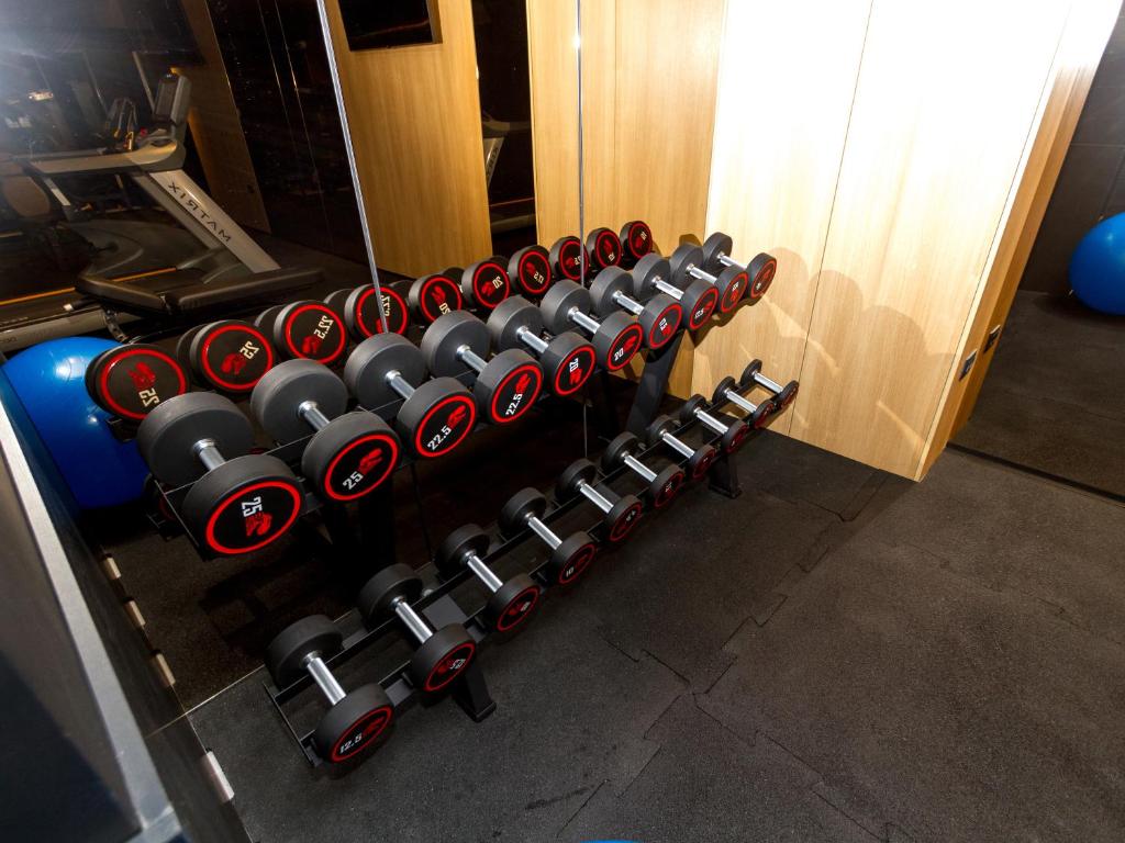 a row of dumbbells in a gym at Regent Resort Budva in Budva