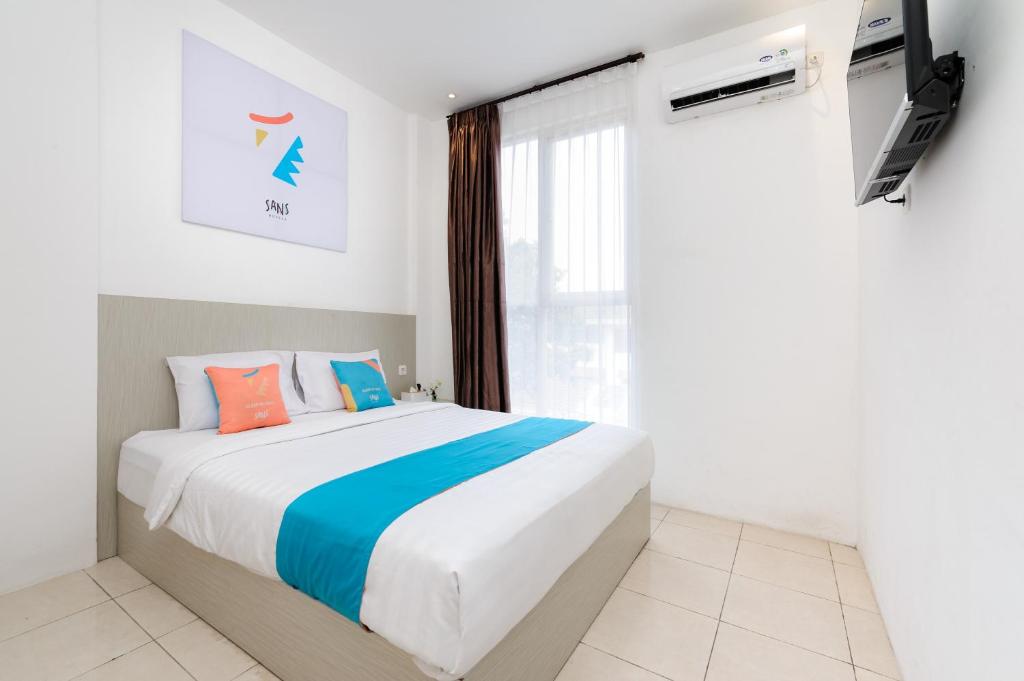Postel nebo postele na pokoji v ubytování Sans Hotel La Vida Malang