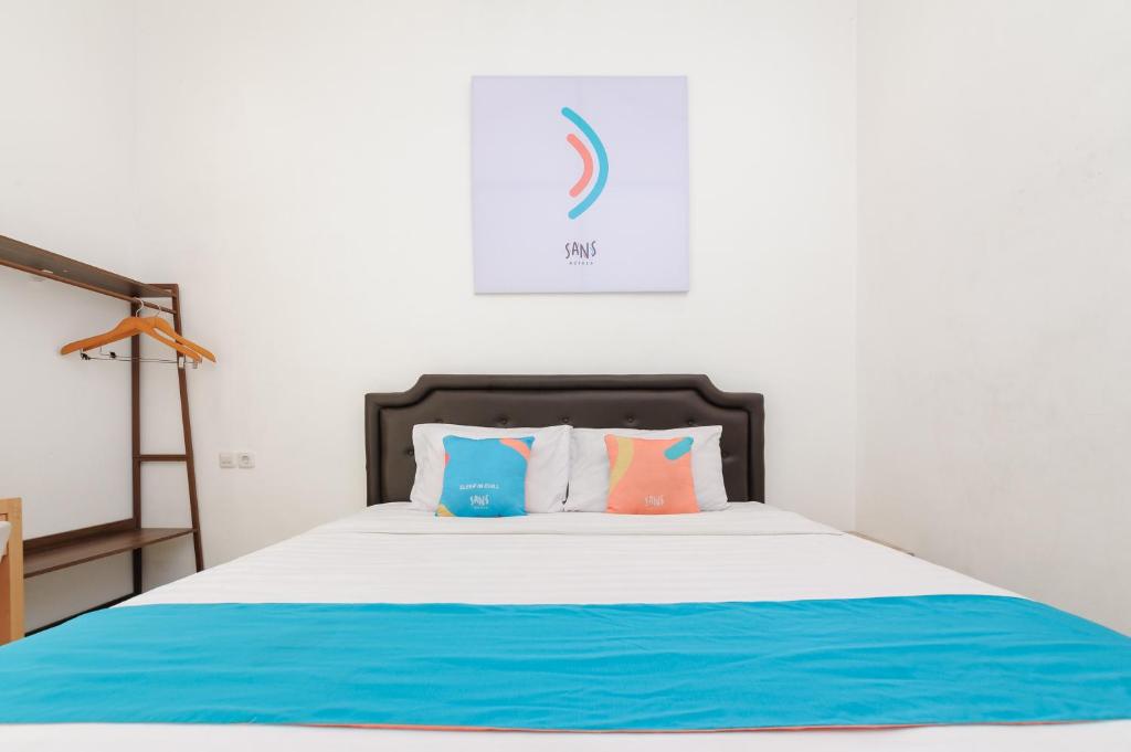 Postel nebo postele na pokoji v ubytování Sans Hotel La Vida Malang