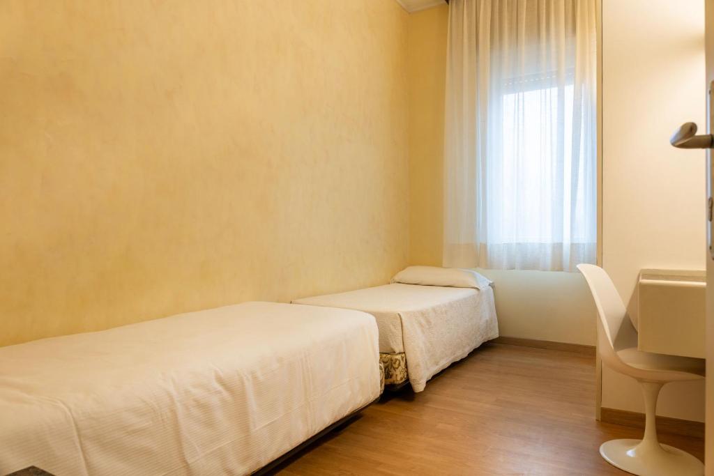 Postel nebo postele na pokoji v ubytování Hotel Rosabianca