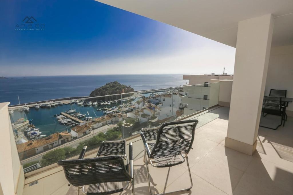 a balcony with two chairs and a view of the ocean at Icon Luxury Seaview Marina in Almuñécar