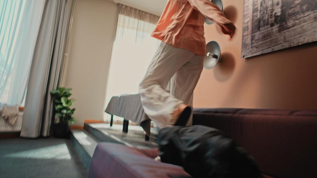 a person is jumping on the back of a couch at Citybox Oslo in Oslo