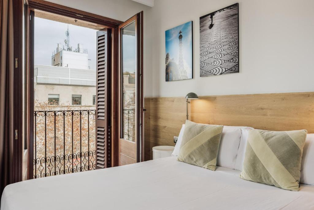 A bed or beds in a room at Ola Living Boqueria
