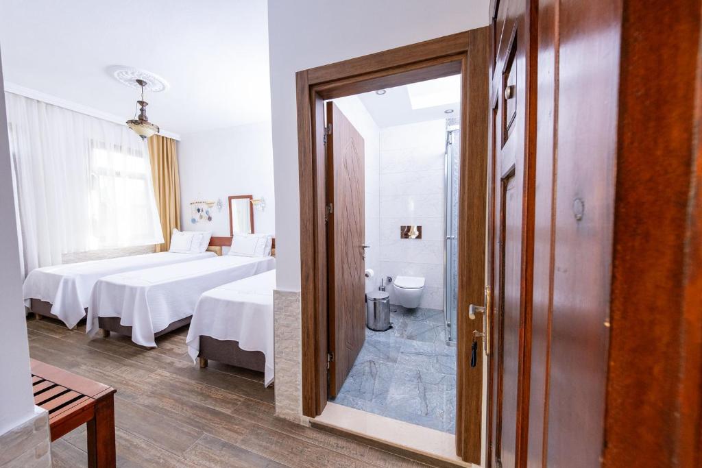 Postel nebo postele na pokoji v ubytování Club Kavala Beach Hotel Assos