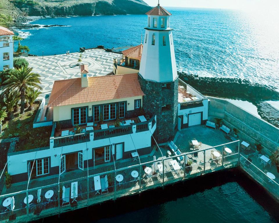 an aerial view of a lighthouse on the water at Dreams Madeira Resort Spa & Marina in Caniçal