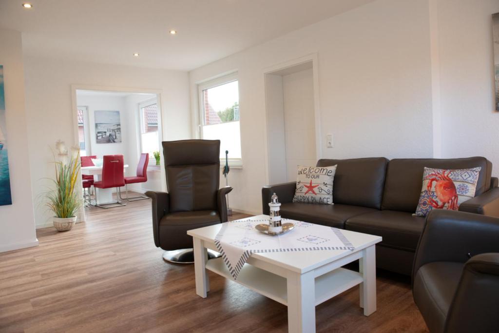 a living room with a couch and a coffee table at Deichhaus vorne in Norden
