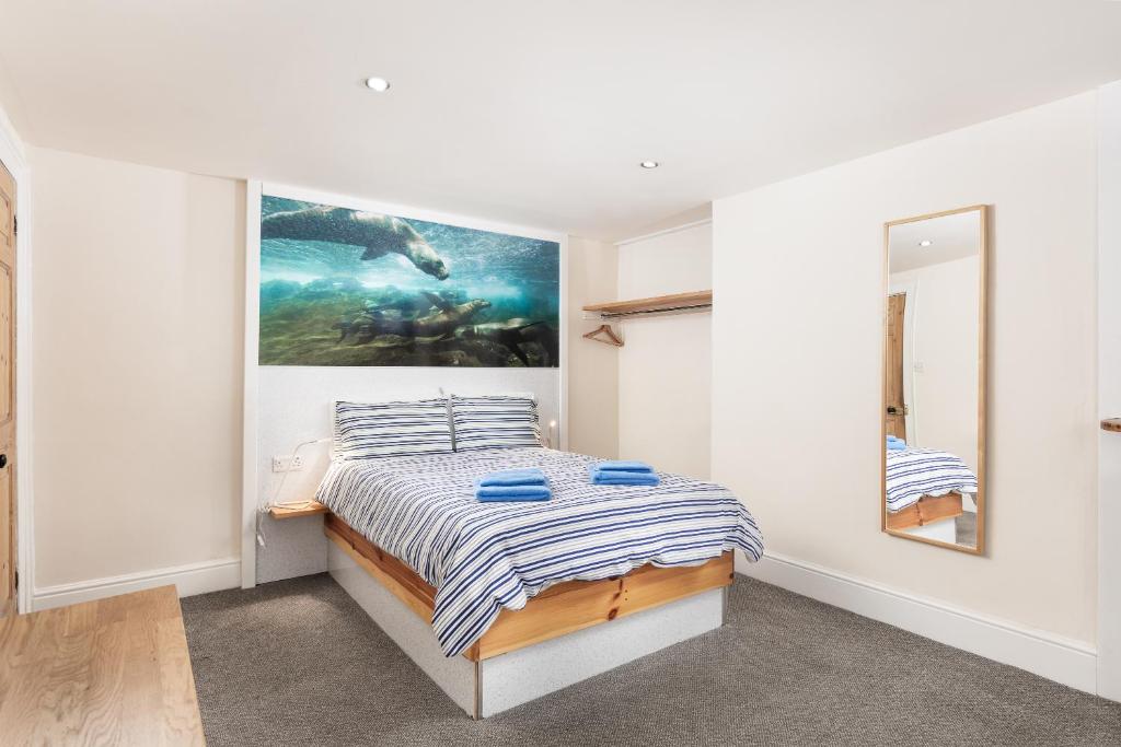 a bedroom with a bed and a painting on the wall at Discovery House in Whitby