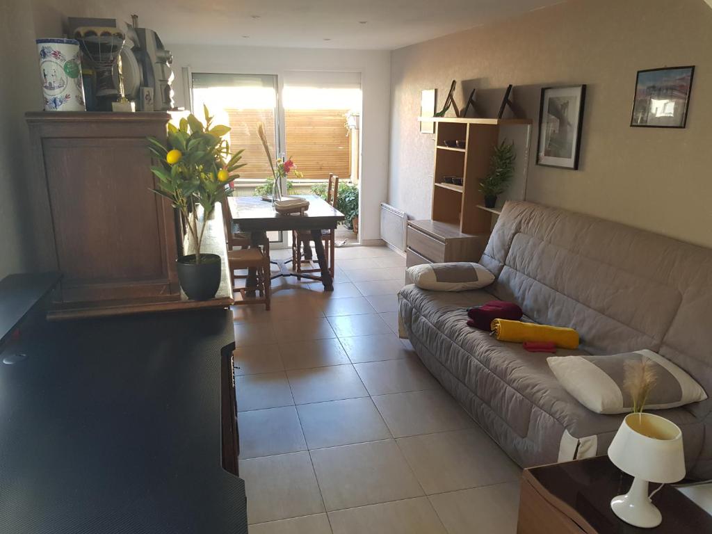 a living room with a couch and a table at Entire apartment 62 m2 3 rooms 1st floor in Bezons