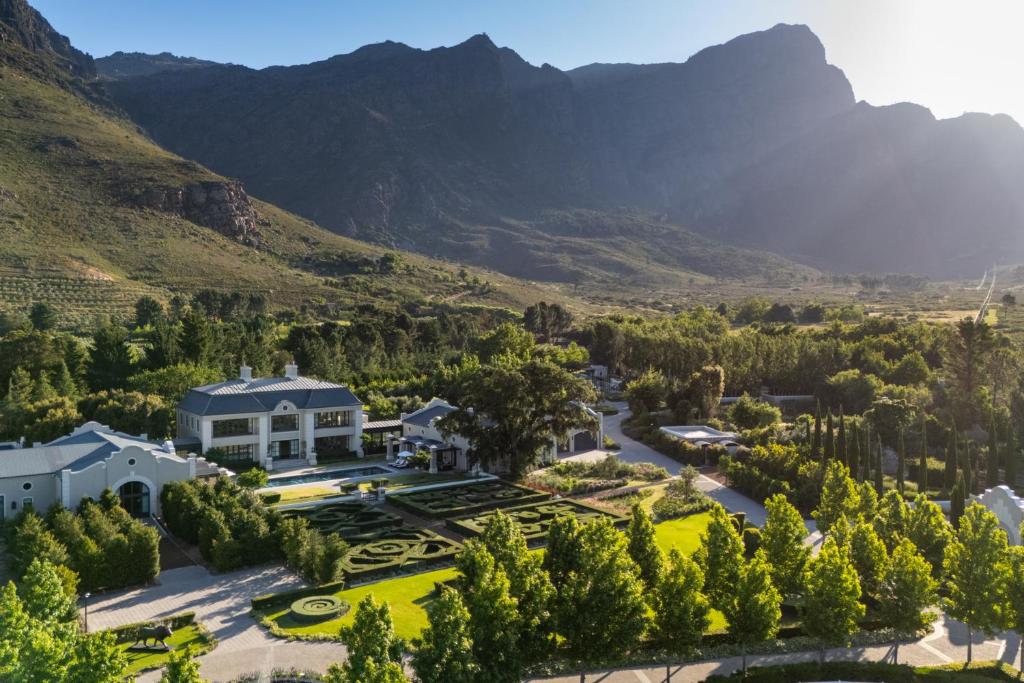 an aerial view of a mansion with mountains in the background at Oakvale Estate in Franschhoek
