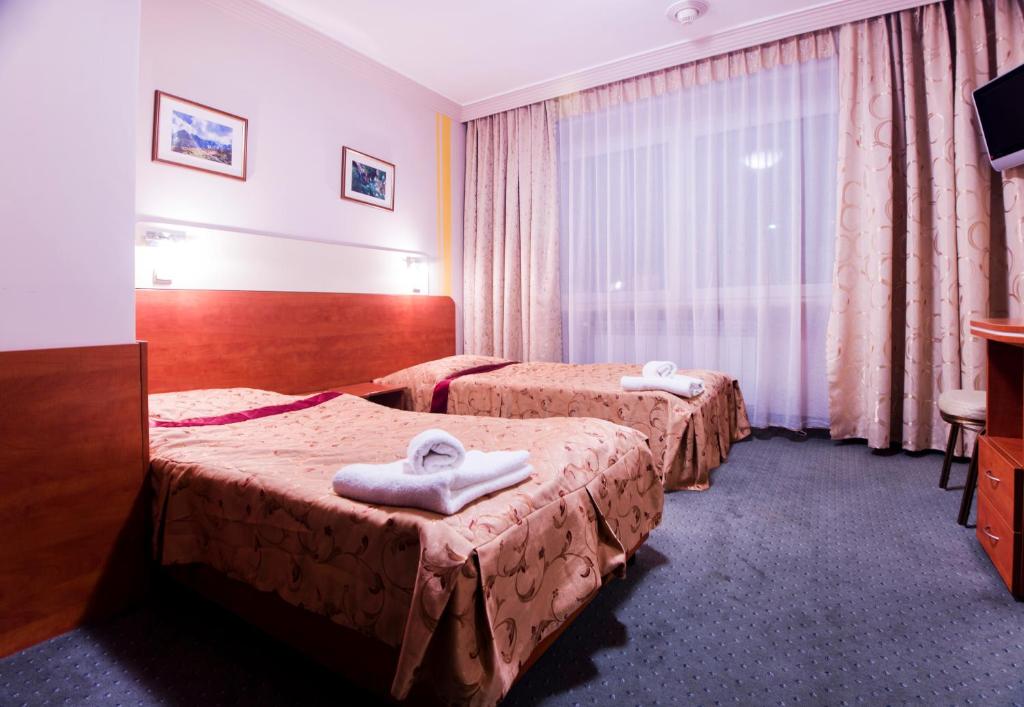 Postel nebo postele na pokoji v ubytování Hotel Orion
