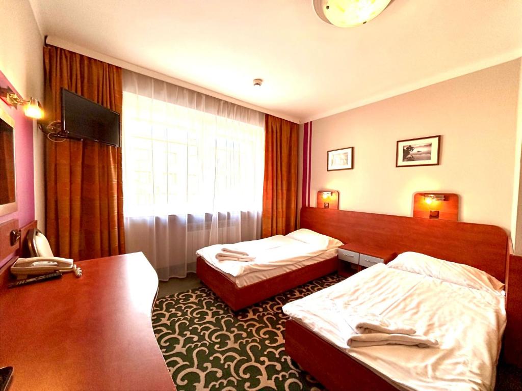 Postel nebo postele na pokoji v ubytování Hotel Orion