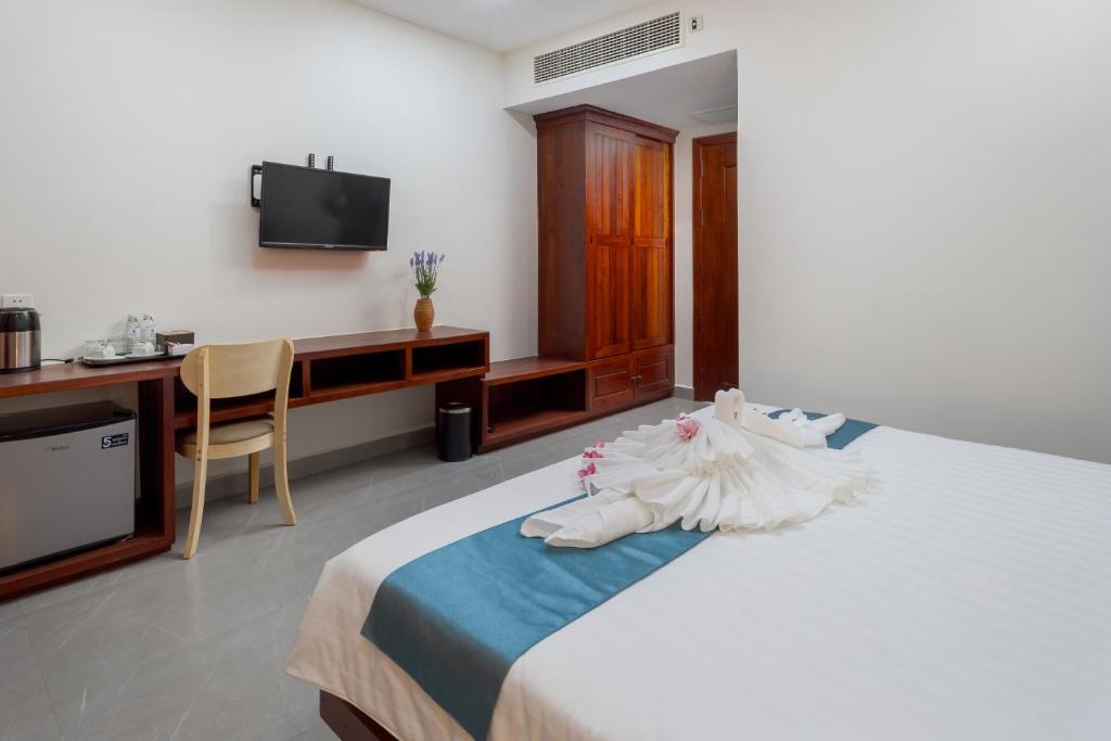 Postel nebo postele na pokoji v ubytování Angkor Channary Hotel