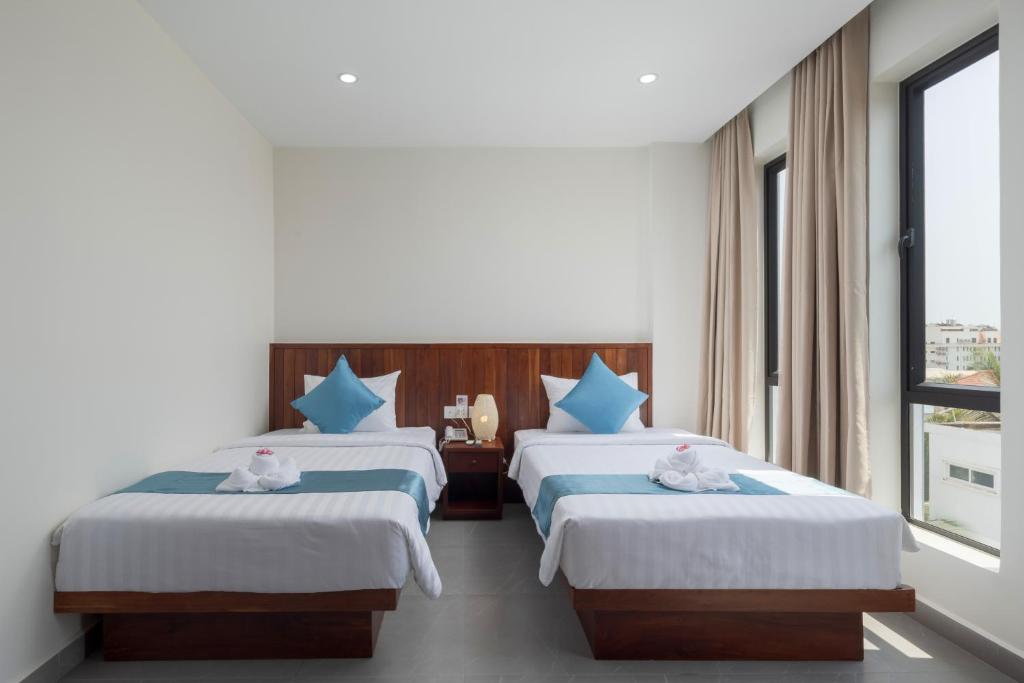 Postel nebo postele na pokoji v ubytování Angkor Channary Hotel