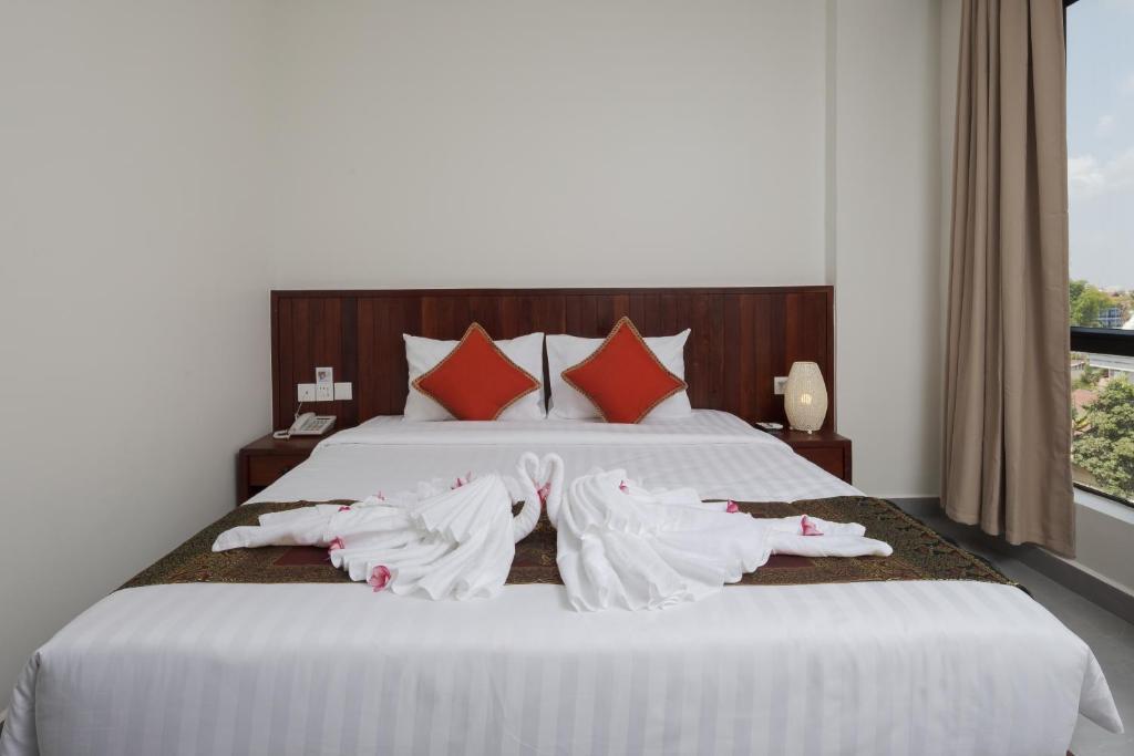 Postel nebo postele na pokoji v ubytování Angkor Channary Hotel