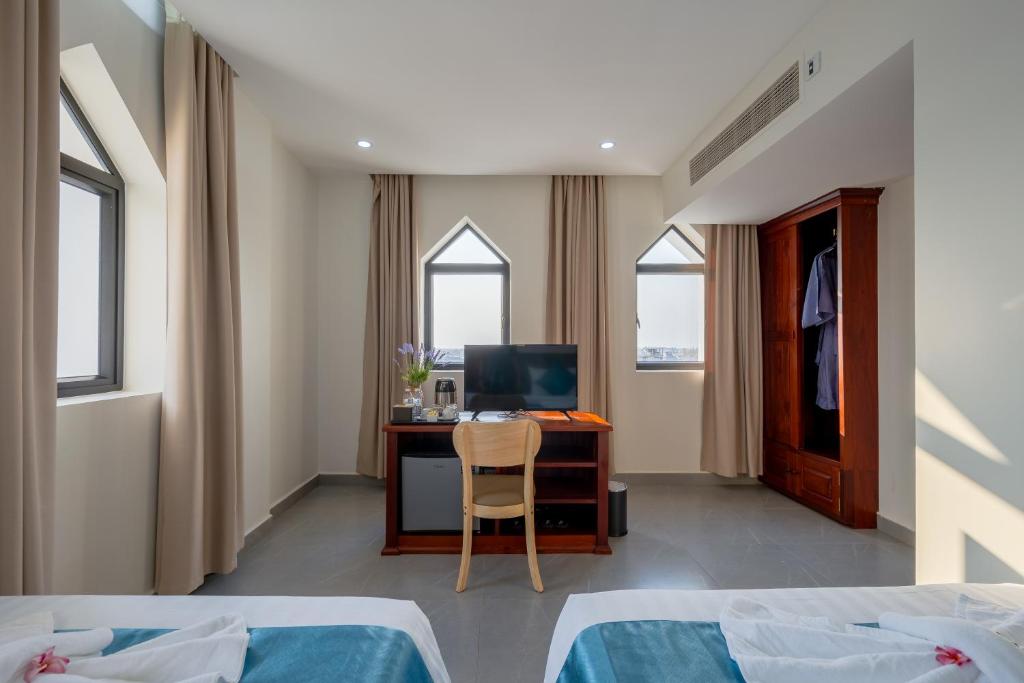 Postel nebo postele na pokoji v ubytování Angkor Channary Hotel