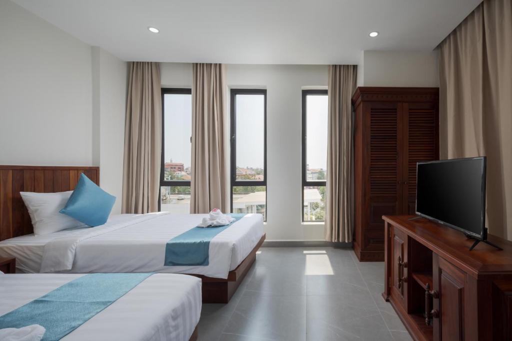 Postel nebo postele na pokoji v ubytování Angkor Channary Hotel