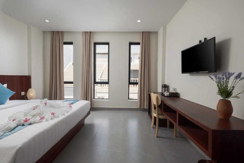 Postel nebo postele na pokoji v ubytování Angkor Channary Hotel