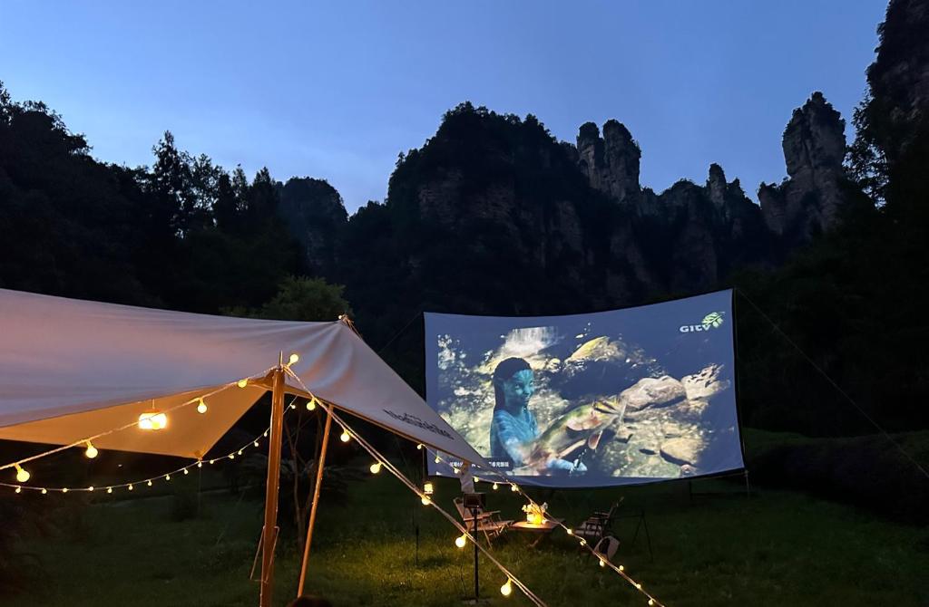 a tent with a picture on the side of it at Cozy Boutique Hotel in Zhangjiajie