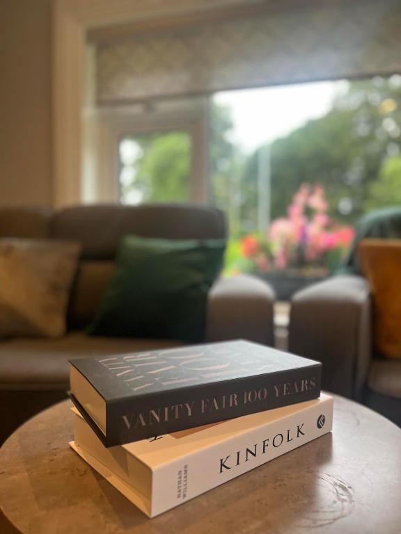 two books sitting on a table in a living room at Laurel cottage in Omagh