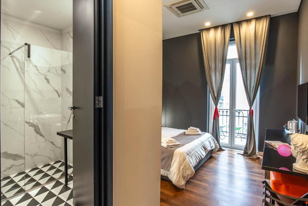 Posteľ alebo postele v izbe v ubytovaní Gram Suites