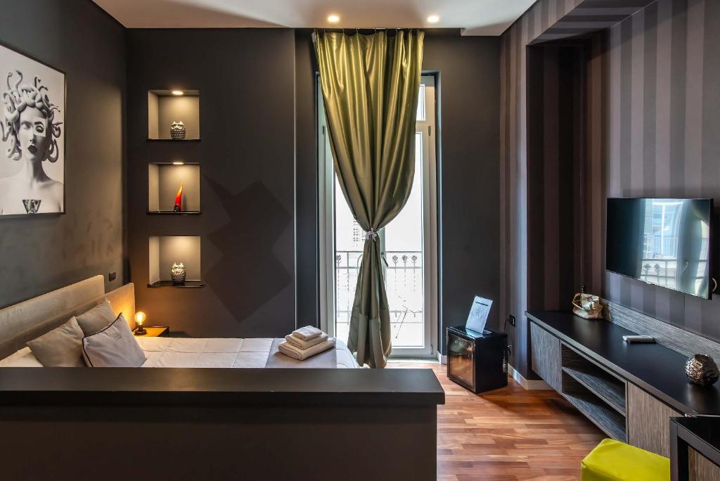 Posteľ alebo postele v izbe v ubytovaní Gram Suites