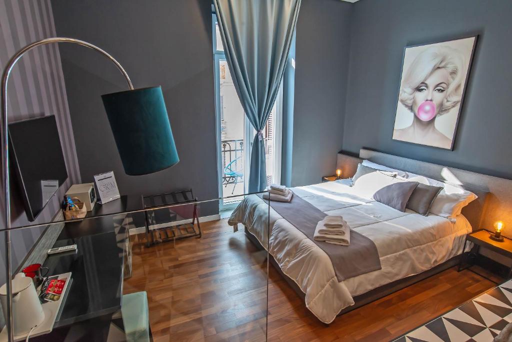 Posteľ alebo postele v izbe v ubytovaní Gram Suites