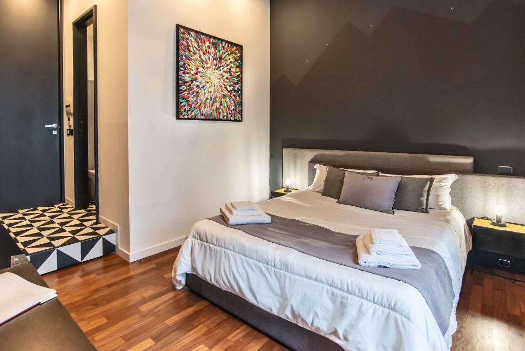 Posteľ alebo postele v izbe v ubytovaní Gram Suites
