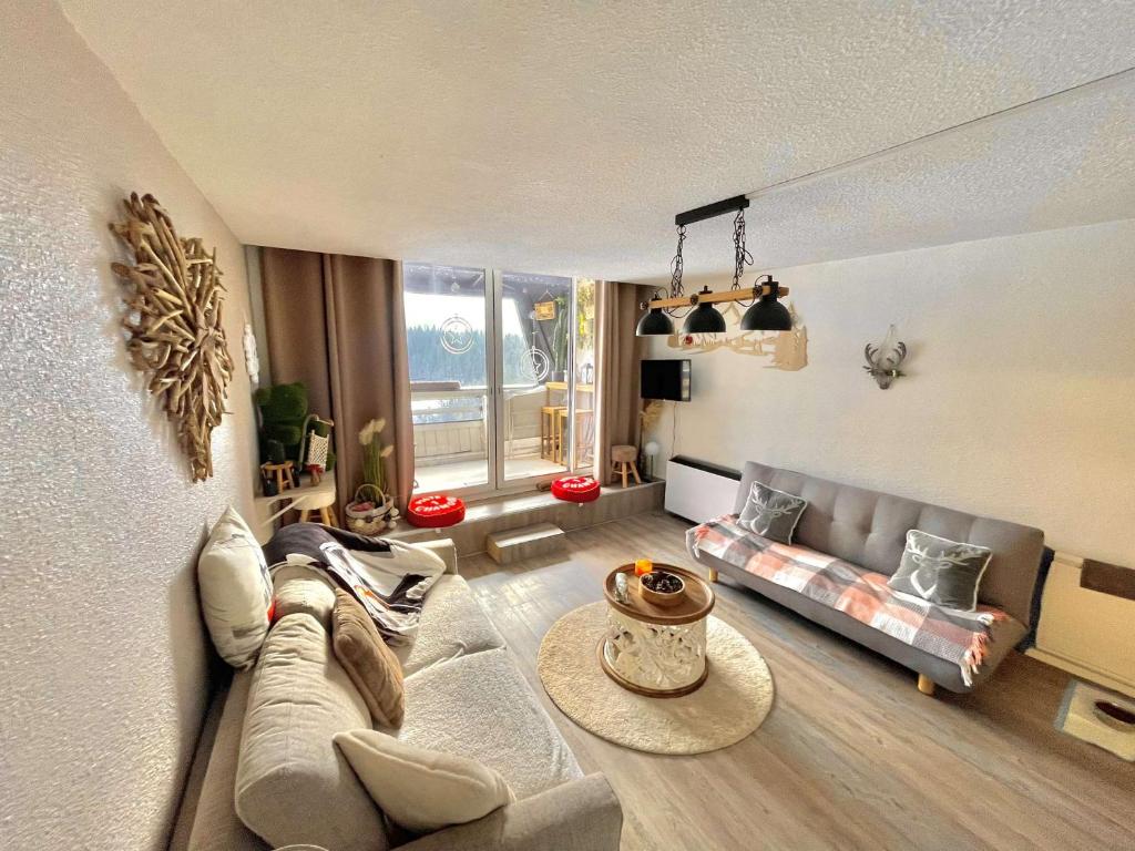 un salon avec un canapé et une table dans l'établissement Chaleureux studio Glovettes VILLARD DE LANS, à Villard-de-Lans