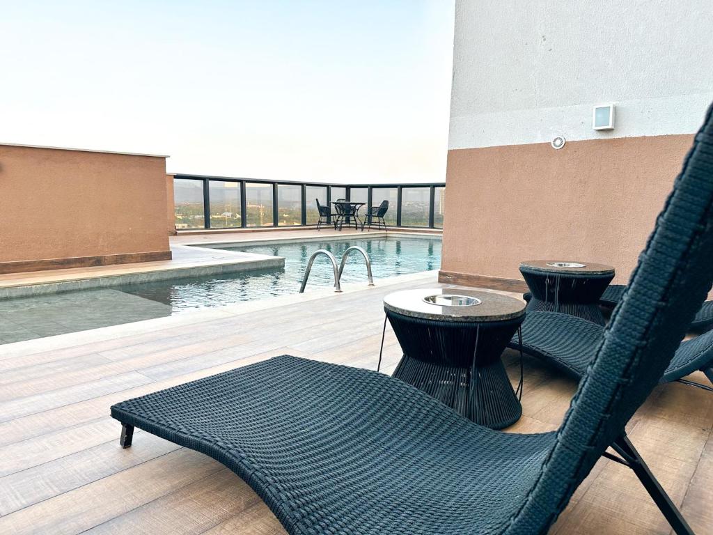 a patio with two chairs and a swimming pool at STAY Cosmopolitan in Palmas