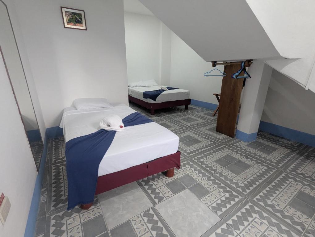 Postel nebo postele na pokoji v ubytování Hostal Gardner