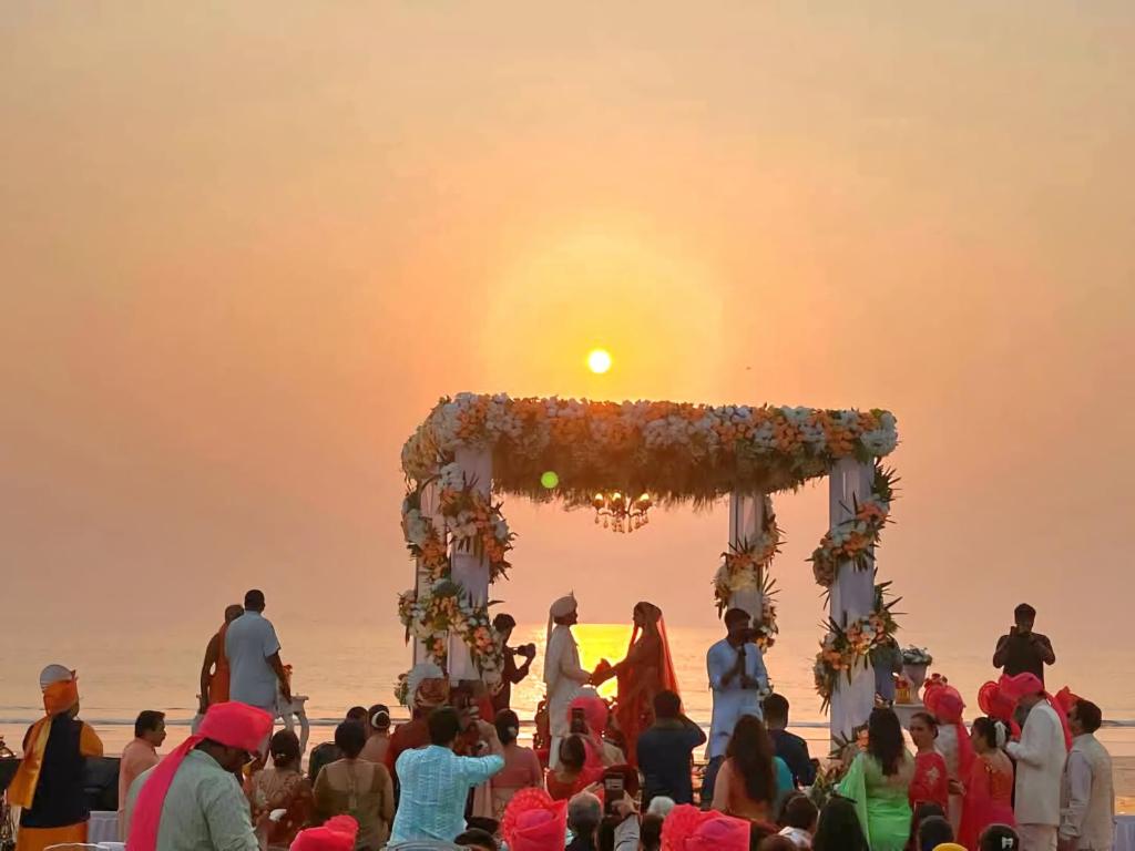 a wedding ceremony on the beach at sunset at Samant Beach Villa in Bhogwe