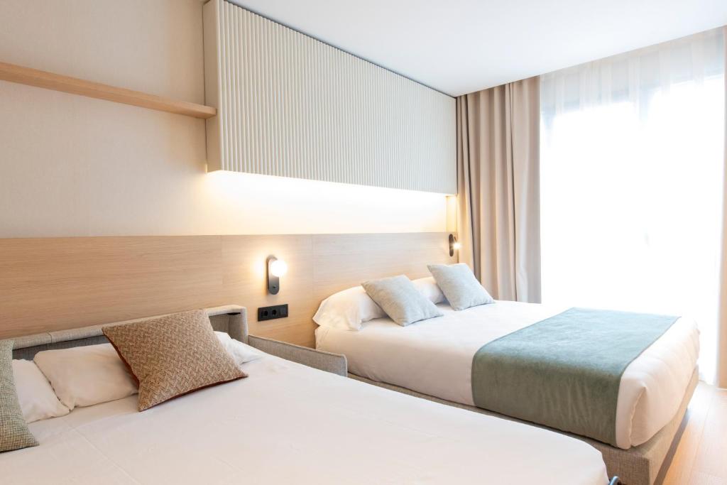 Posteľ alebo postele v izbe v ubytovaní Aparthotel Atenea Calabria