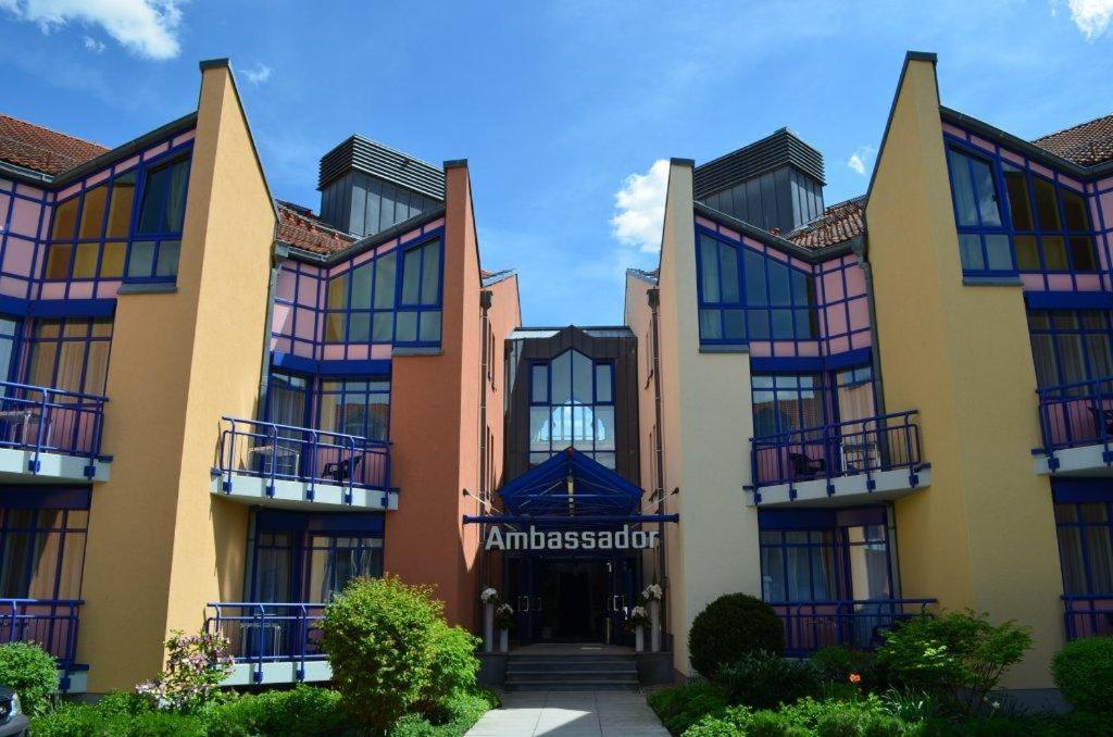 a building with colorful windows on the front of it at Ambassador Hotel in Grasbrunn