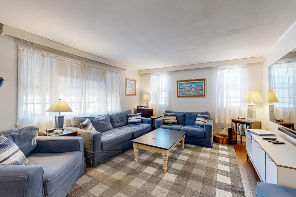 a living room with blue couches and a table at Ann Acres --- 21069 Elizabeth Ave. in Rehoboth Beach