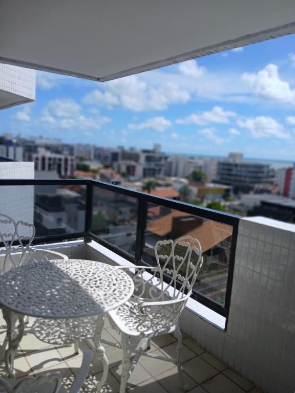 a balcony with a table and chairs and a view at Apartamento 2 ruas beira mar espaçoso 15 pessoas in João Pessoa