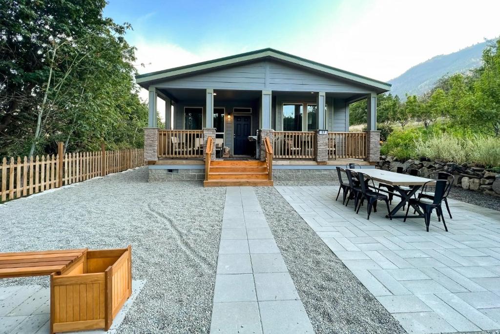 a house with a patio with a table and chairs at Water's Edge Escape in Chelan