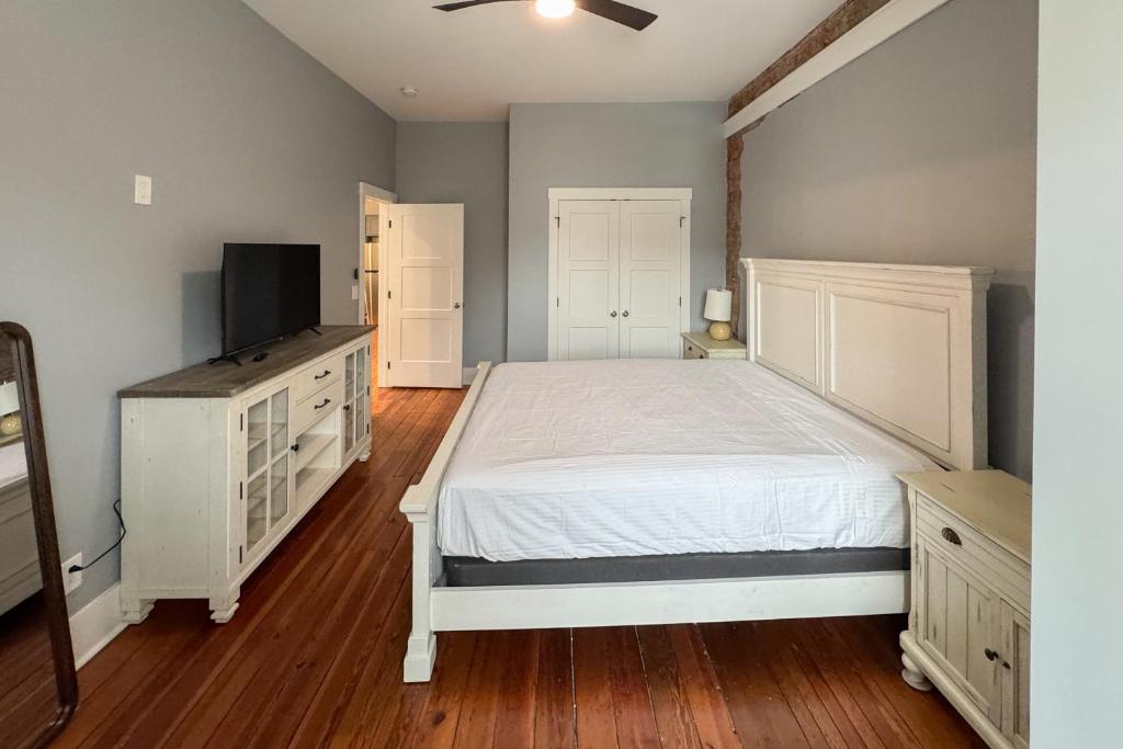 a bedroom with a bed and a flat screen tv at Eagle Claw Den in Waynesville