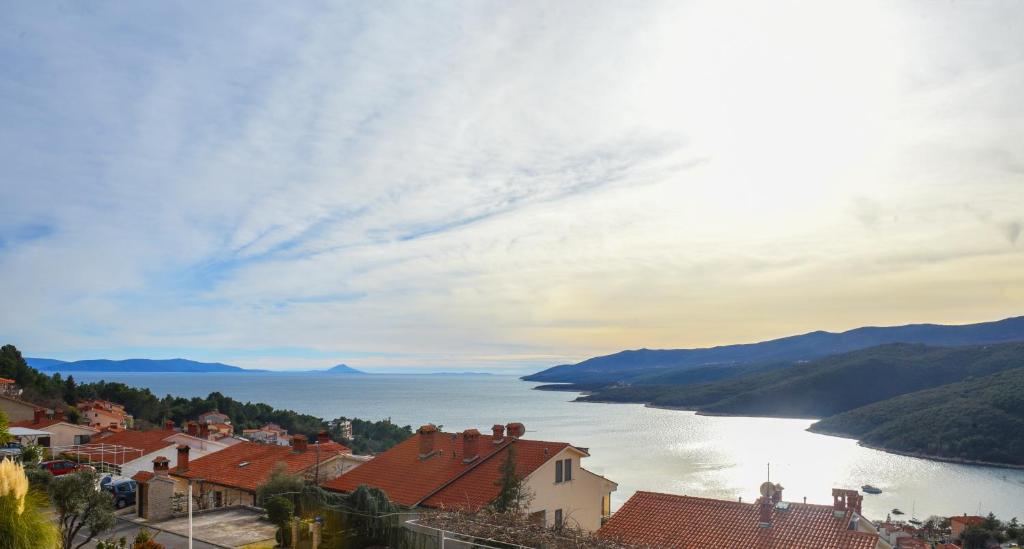a view of a town with a lake and mountains at Seaview Apartment Bojan Rabac in Rabac