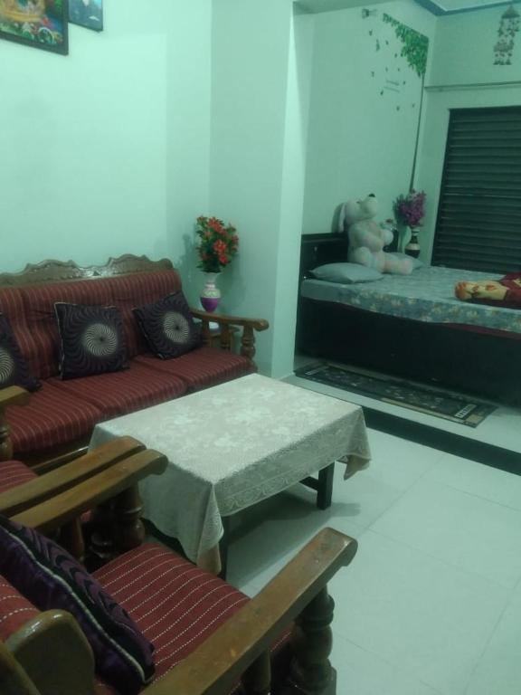 a living room with a couch and a table and a bed at 2 Room set floor in Mathura