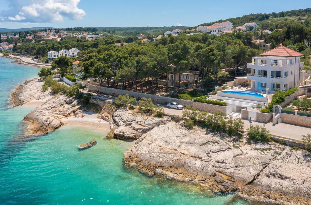 an aerial view of a beach with a house at La Villa - BEACHFRONT - INFINITY HEATED POOL - NEW in Sutivan