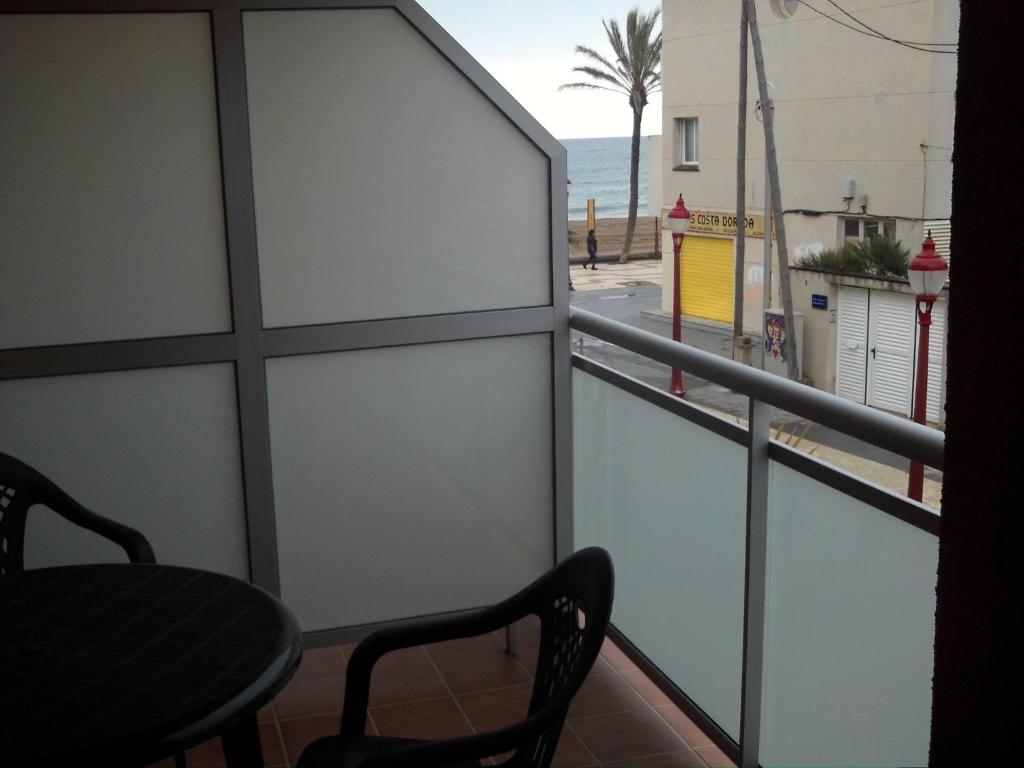 balcón con silla y vistas a la playa en Hostal Cubelles, en Cubelles