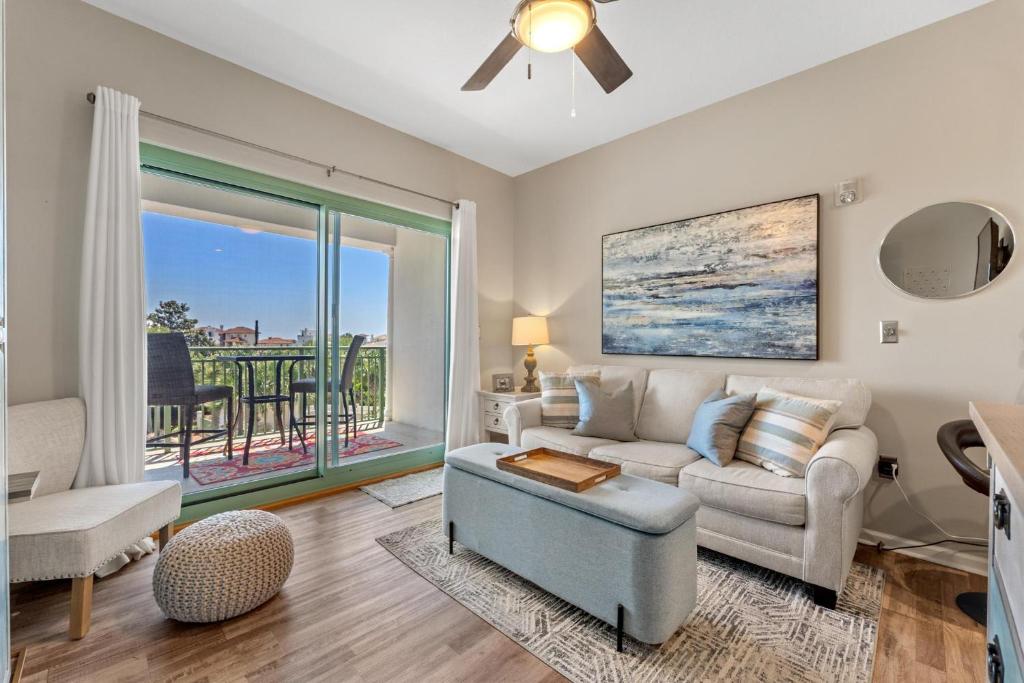 a living room with a couch and a table at Inn at Seacrest 309- Somewhere in the Sun in Inlet Beach